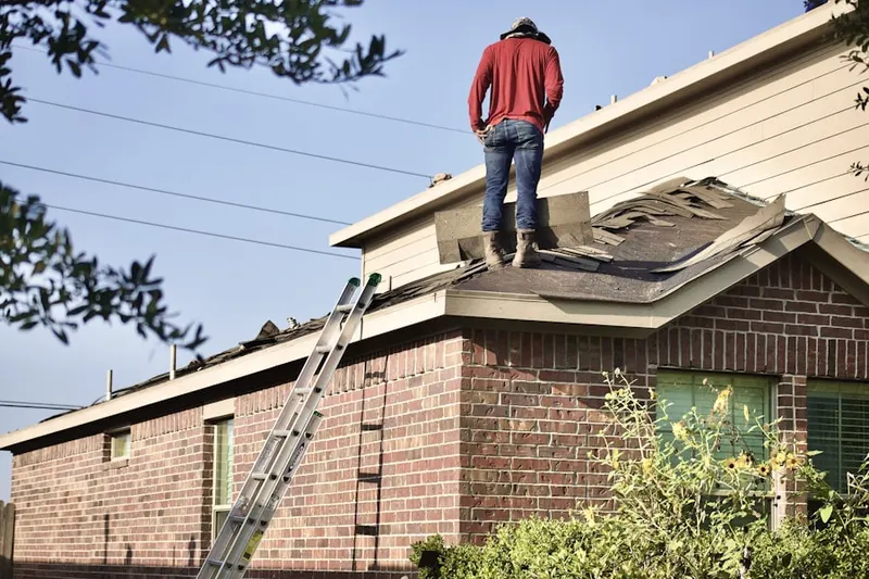 Professional roofer working on a residential roof in Medinah